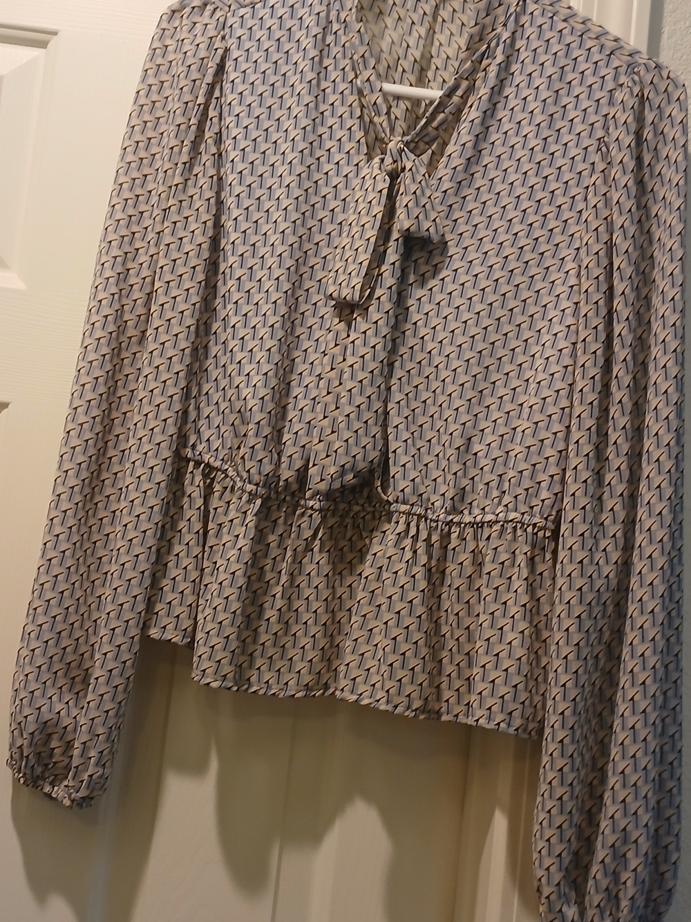 Cream Geometric Tie-Neck Peplum Blouse